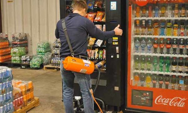 Man using Airsled to move a vending machine