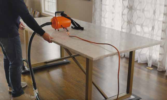 Moving heavy furniture over wood flooring with an Airsled