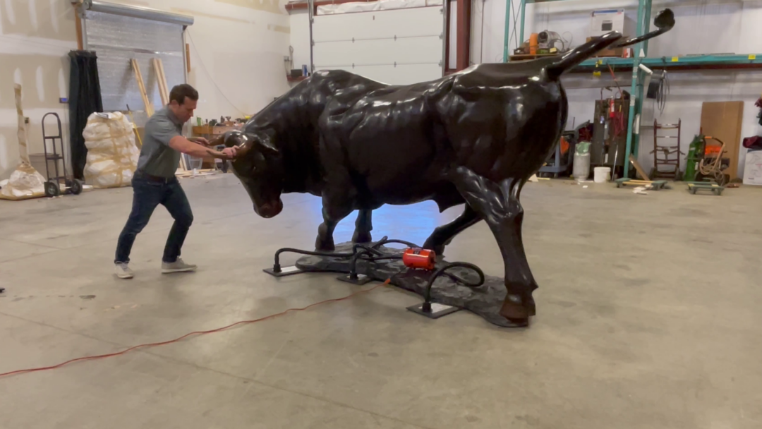 Bronze statue of a bull being moved by the Airsled 3-in-1 moving system